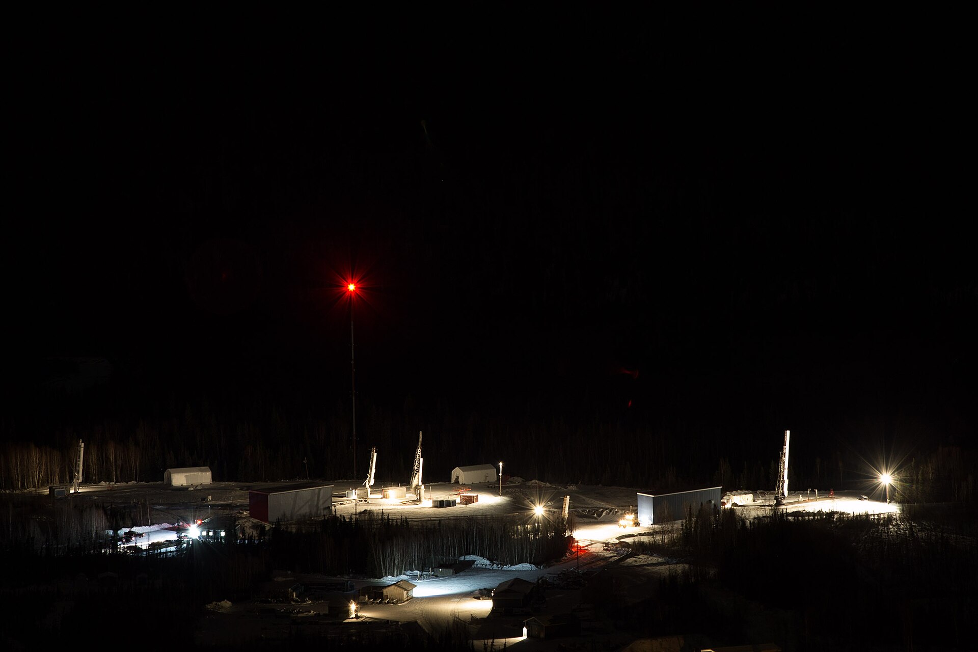 Photo of sounding rockets lit up on the launch pads at night at Poker Flat Research Range near Chatanika and Fairbanks, Alaska