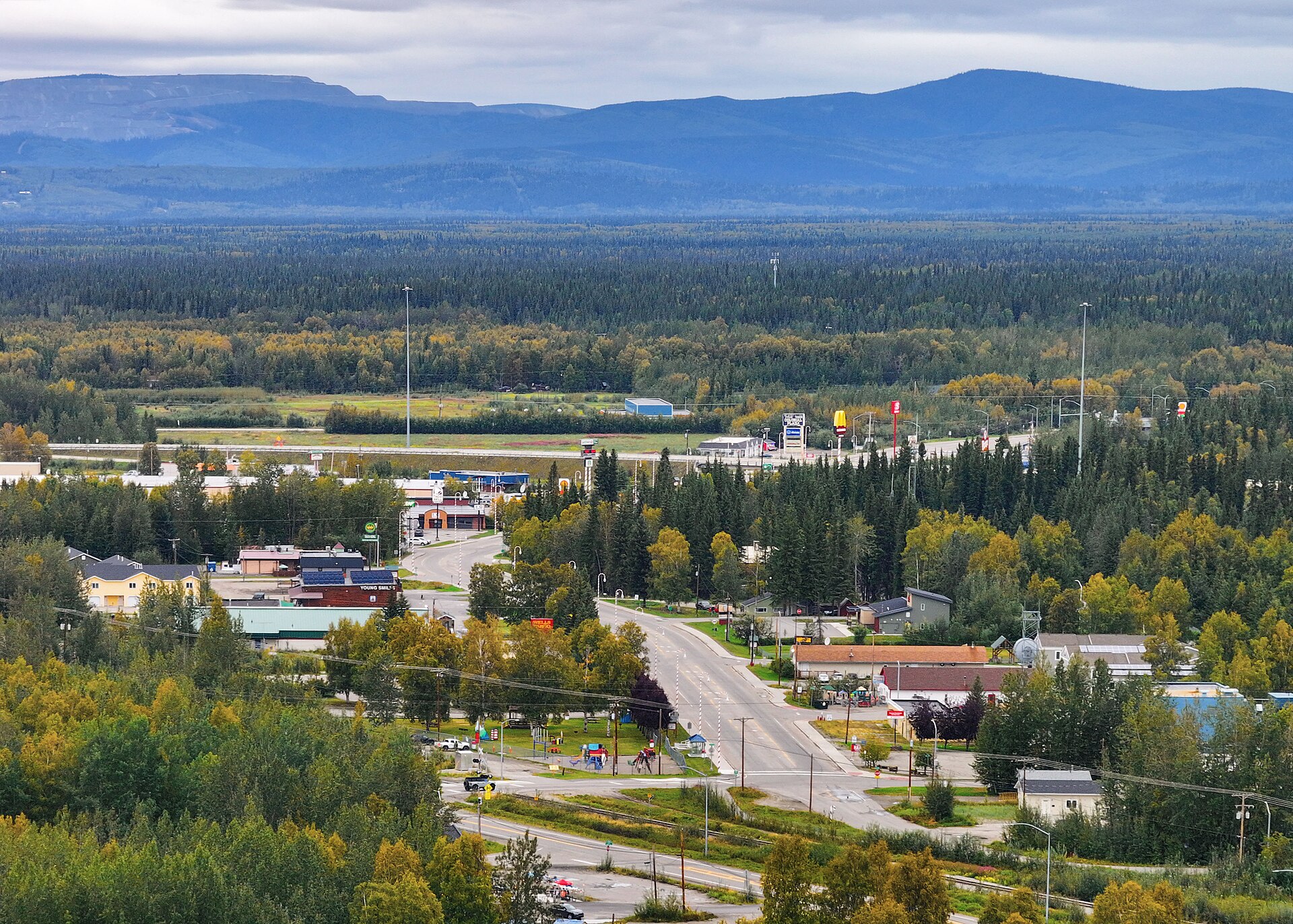 Aerial photo of downtown North Pole, Alaska, with local businesses, streets, and fall birch and spruce, near Fairbanks